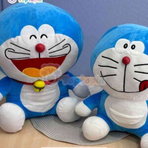 Peluche Doraemon original azul sentado, gato cósmico con nariz roja y sonrisa tierna